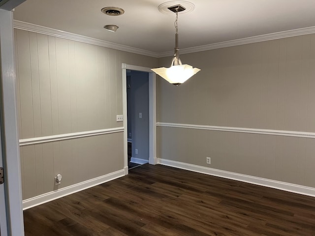 spare room featuring dark wood-type flooring and ornamental molding