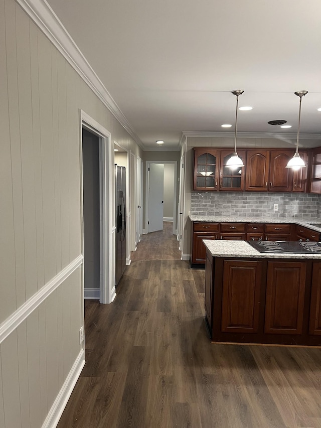 kitchen with decorative light fixtures, tasteful backsplash, stainless steel fridge, dark hardwood / wood-style flooring, and dark brown cabinets