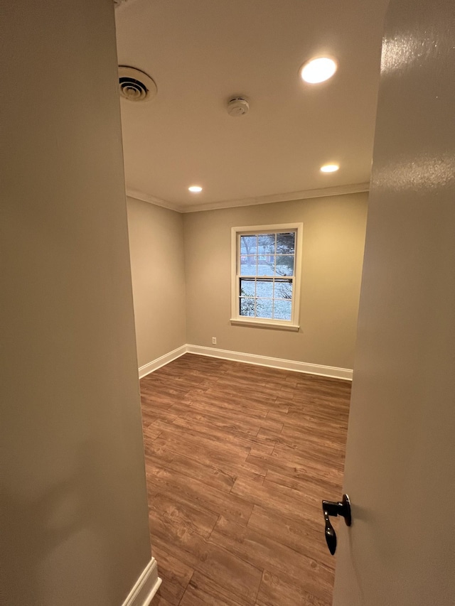 unfurnished room featuring ornamental molding and hardwood / wood-style floors