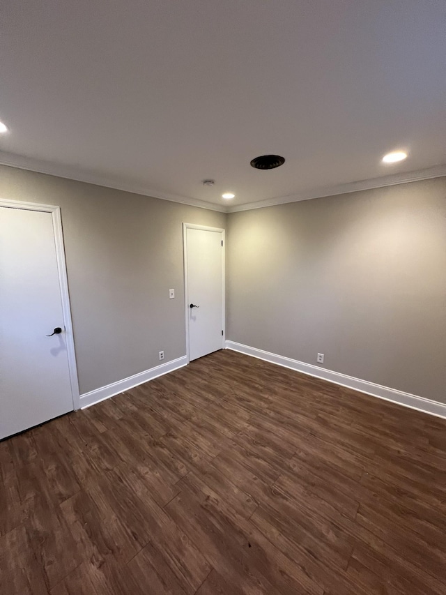 unfurnished room with ornamental molding and dark hardwood / wood-style floors