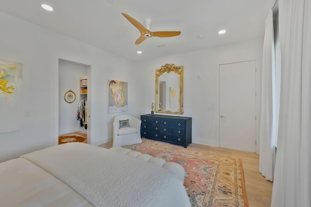 bedroom with ceiling fan and light wood-type flooring