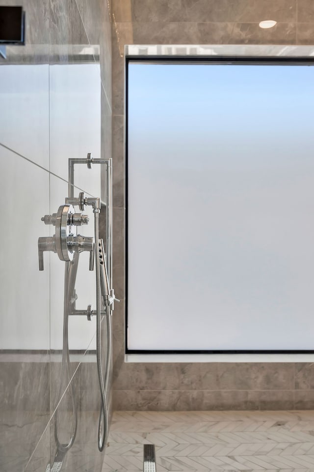 bathroom with tile patterned floors and a shower