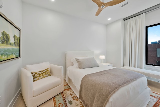 bedroom with ceiling fan and light hardwood / wood-style flooring