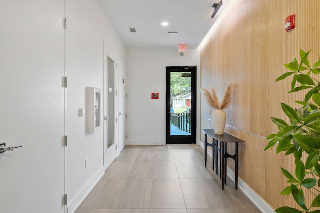 corridor with light tile patterned floors