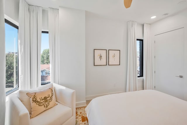 bedroom with light hardwood / wood-style flooring and ceiling fan