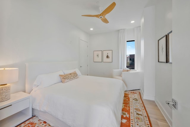 bedroom with ceiling fan and light wood-type flooring