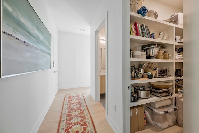 corridor featuring light hardwood / wood-style floors