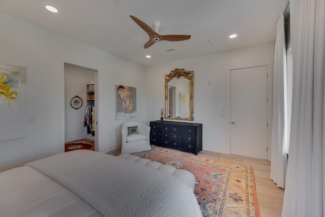 bedroom with ceiling fan and light hardwood / wood-style flooring