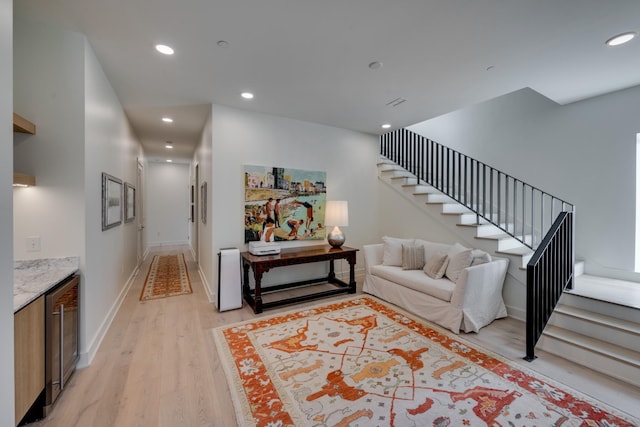 living room featuring beverage cooler and light wood-type flooring