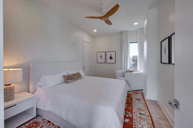 bedroom with ceiling fan and light hardwood / wood-style flooring