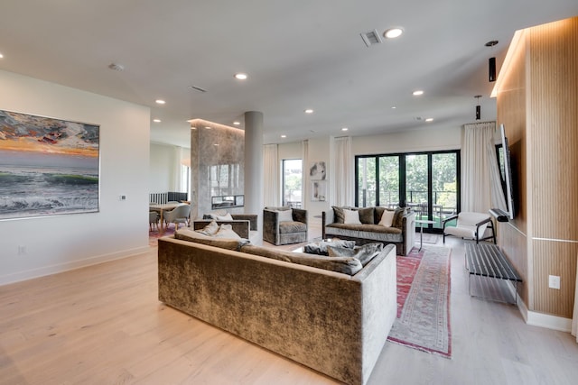 living room featuring french doors and light hardwood / wood-style flooring