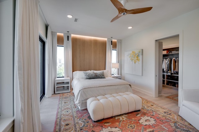 bedroom with ceiling fan, a closet, and light hardwood / wood-style flooring