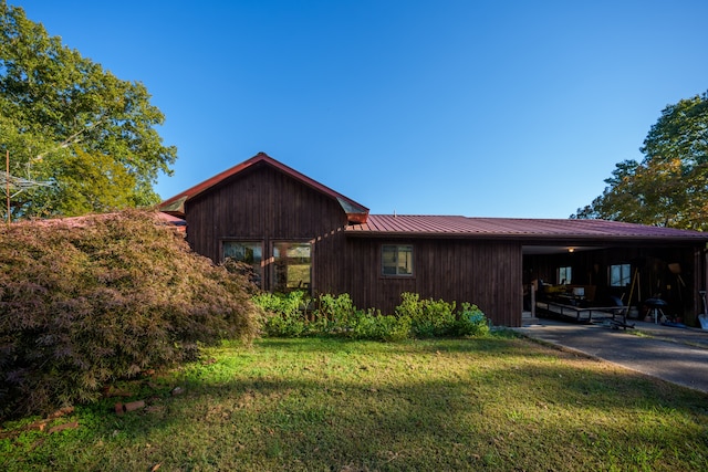 view of property exterior with a yard and a patio area