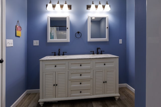 bathroom with vanity and hardwood / wood-style floors