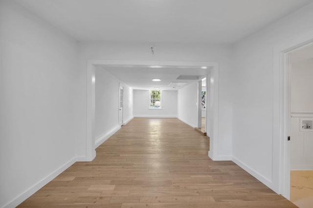 corridor with light wood-type flooring