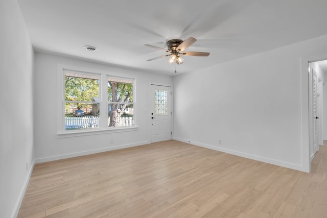 spare room with light wood-type flooring and ceiling fan