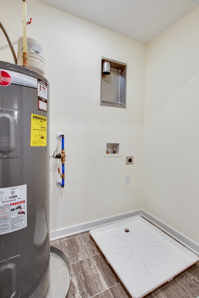 washroom featuring washer hookup, hookup for an electric dryer, water heater, and dark hardwood / wood-style floors