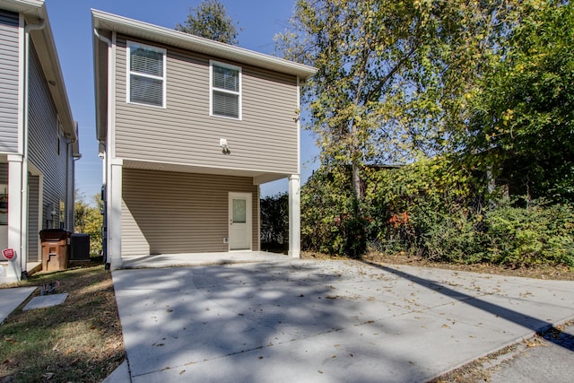 view of home's exterior with a carport and central AC unit