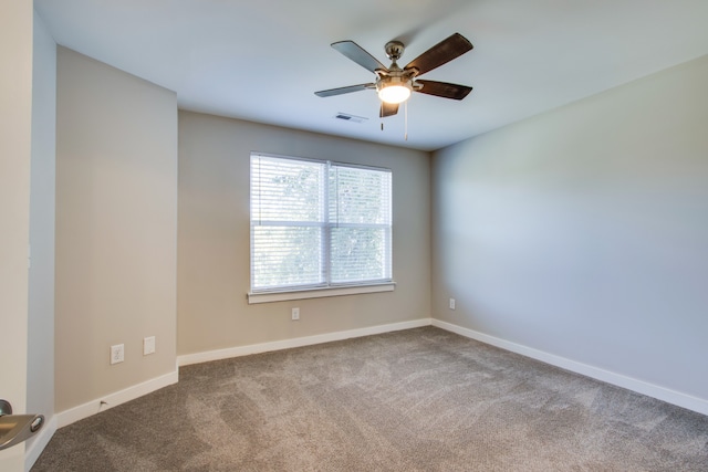 carpeted spare room with ceiling fan