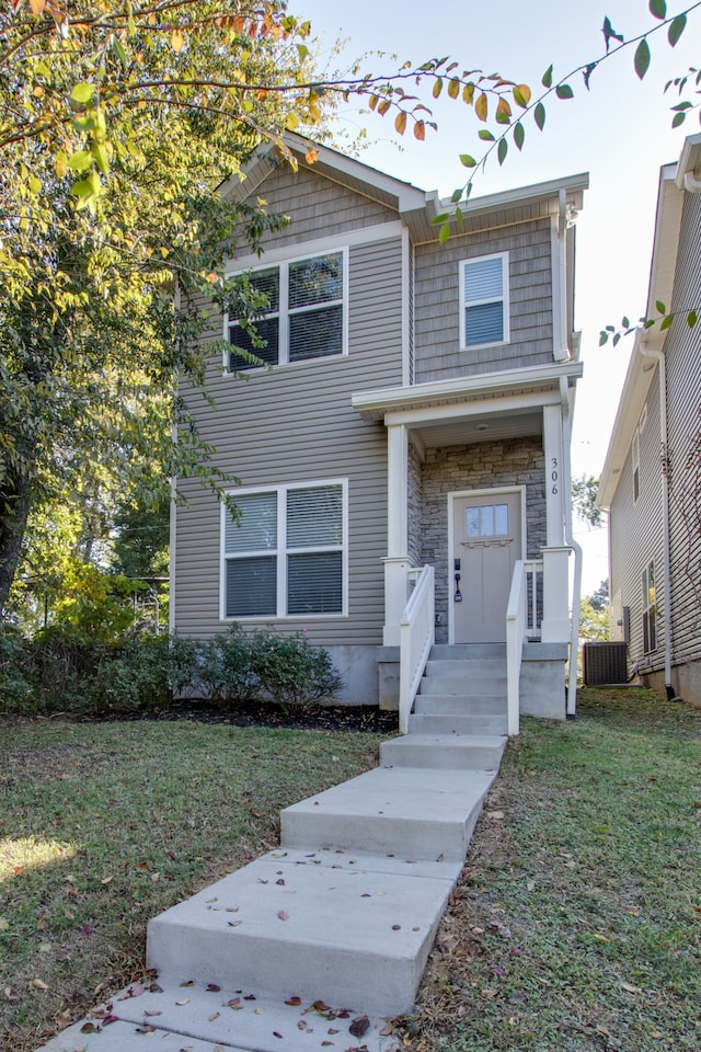 view of front facade with a front lawn and central AC unit