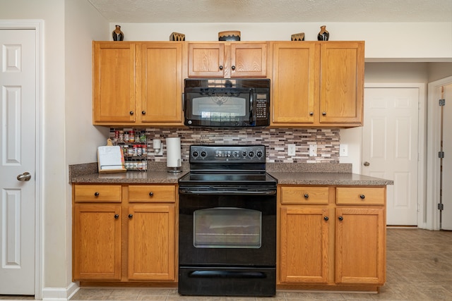 kitchen featuring black appliances and backsplash