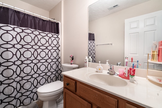 bathroom featuring toilet, a textured ceiling, vanity, and a shower with shower curtain