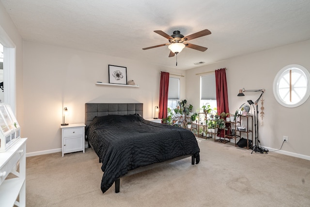 carpeted bedroom featuring a textured ceiling and ceiling fan