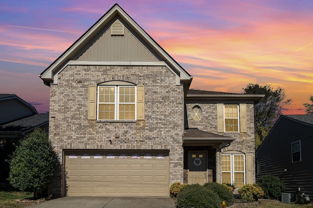 front facade featuring cooling unit and a garage