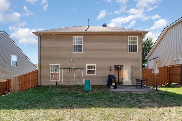 rear view of property featuring a patio and a lawn