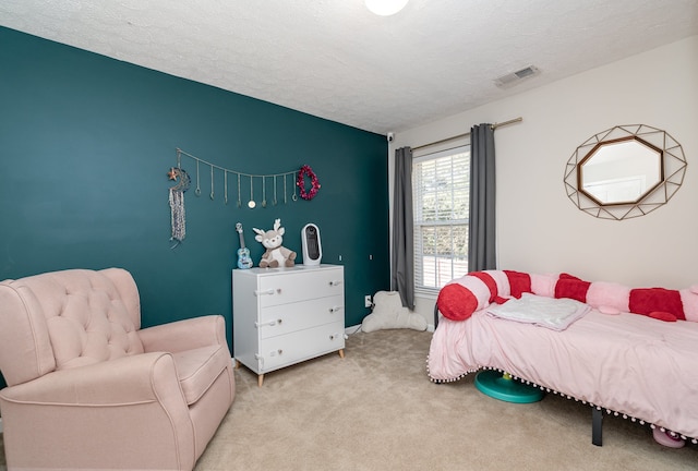 carpeted bedroom featuring a textured ceiling