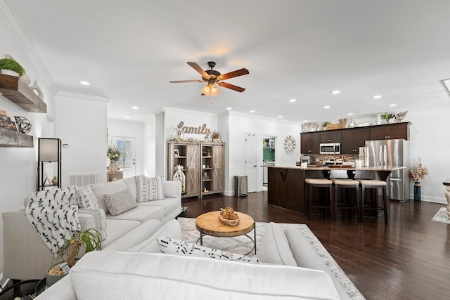 living room featuring crown molding, dark wood-type flooring, and ceiling fan