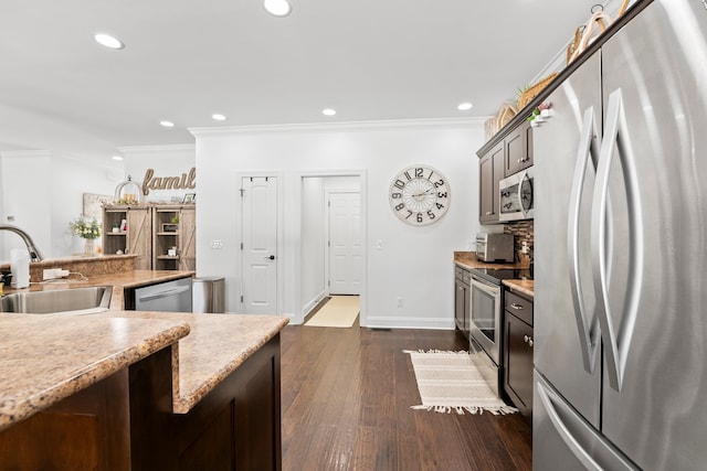 kitchen featuring crown molding, stainless steel appliances, sink, and dark hardwood / wood-style flooring