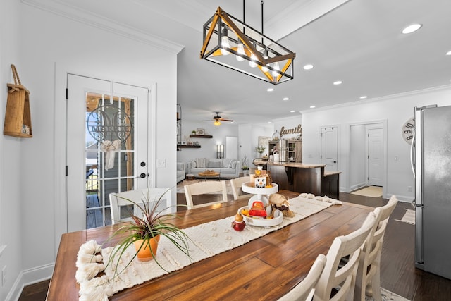 dining space featuring dark wood-type flooring, ceiling fan, and ornamental molding