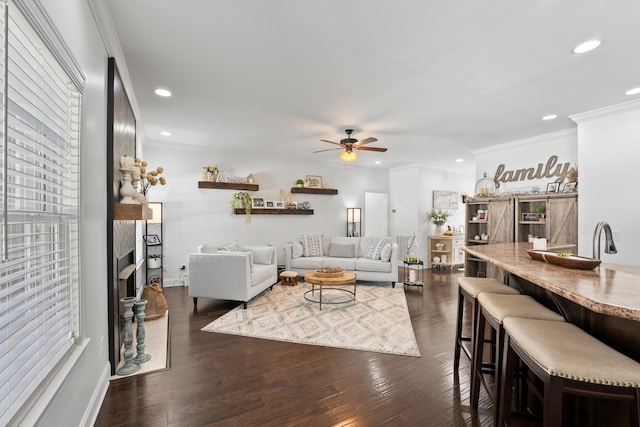 living room featuring ornamental molding, ceiling fan, and dark hardwood / wood-style flooring