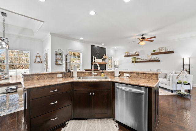 kitchen featuring dark hardwood / wood-style floors, stainless steel dishwasher, a center island with sink, and sink