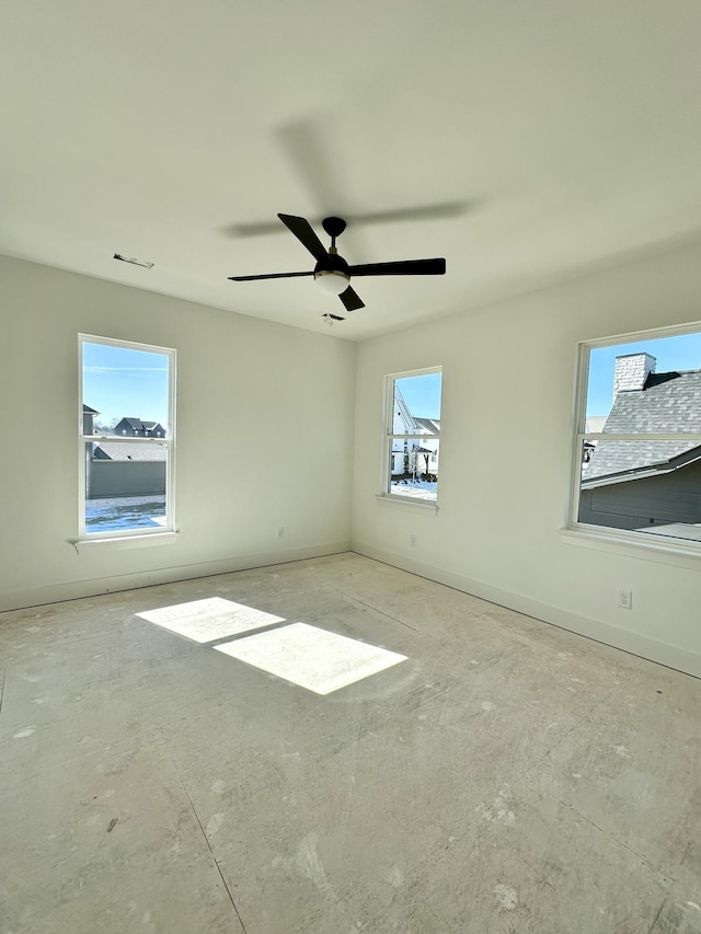 spare room with visible vents, baseboards, and a ceiling fan