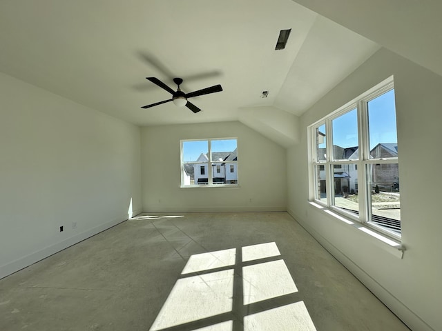 interior space featuring lofted ceiling, a ceiling fan, a residential view, and baseboards