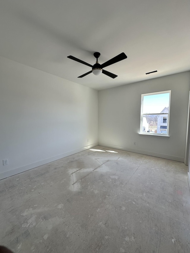 spare room featuring a ceiling fan, visible vents, and baseboards