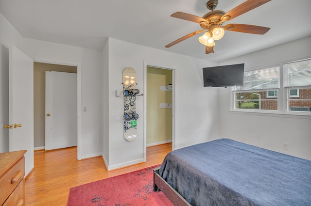 bedroom with light hardwood / wood-style flooring and ceiling fan