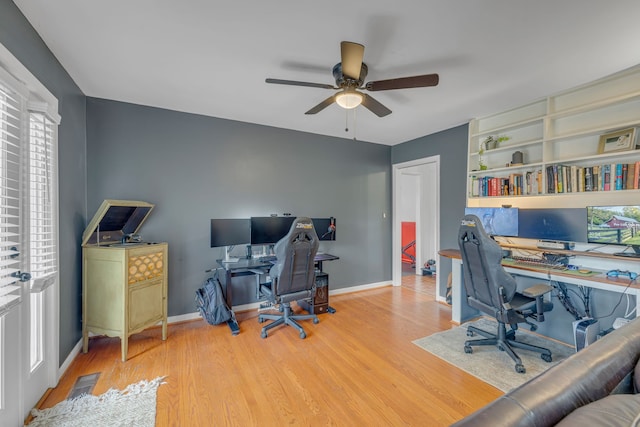 home office with hardwood / wood-style flooring and ceiling fan