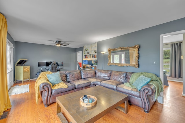 living room featuring light hardwood / wood-style floors and ceiling fan