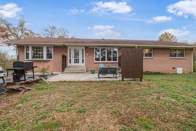 back of house featuring a yard and a patio area