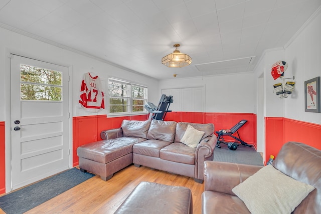 living room featuring ornamental molding, hardwood / wood-style floors, and a healthy amount of sunlight