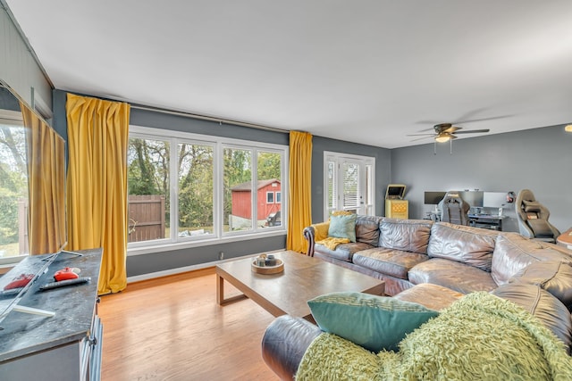 living room featuring light hardwood / wood-style floors, a wealth of natural light, and ceiling fan