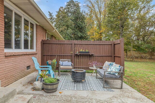 view of patio featuring an outdoor living space with a fire pit