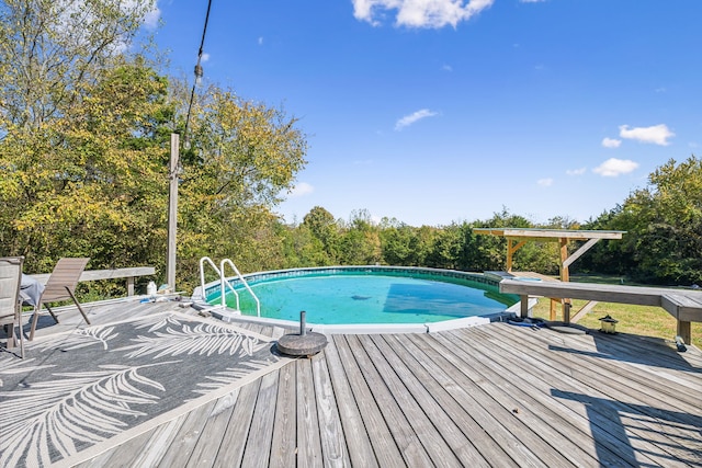 view of pool with a wooden deck