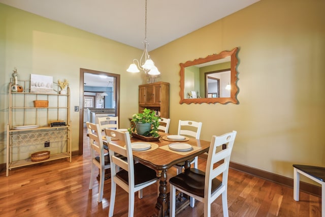 dining room featuring an inviting chandelier and dark hardwood / wood-style flooring