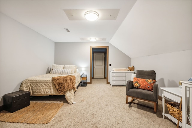 bedroom featuring vaulted ceiling and light carpet