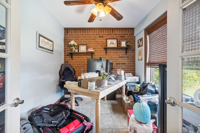 office with ceiling fan, brick wall, and light tile patterned flooring