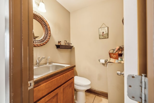 bathroom with vanity, toilet, and tile patterned flooring